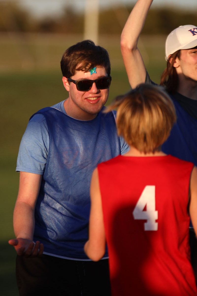 Smiling, sophomore Ian Weatherman chats with an opponent. 