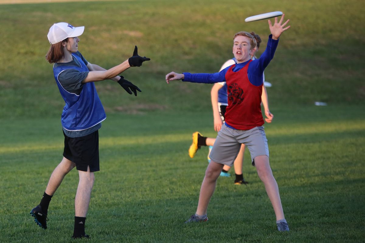 Passing to her teammate, senior Georgia Hansen just barely slips the frisbee past an opponent. 