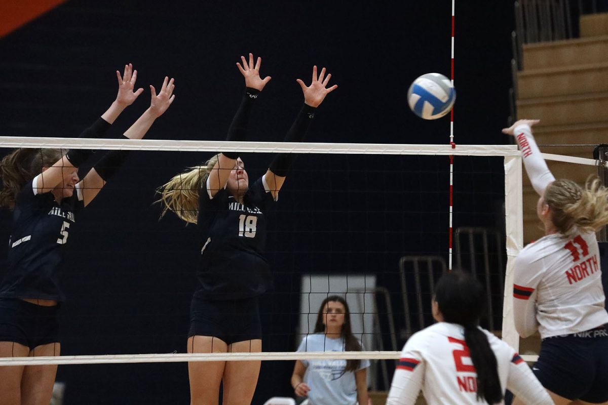 Blocking a spike, junior Saida Jacobs and freshman Riley Riggs defend the net.