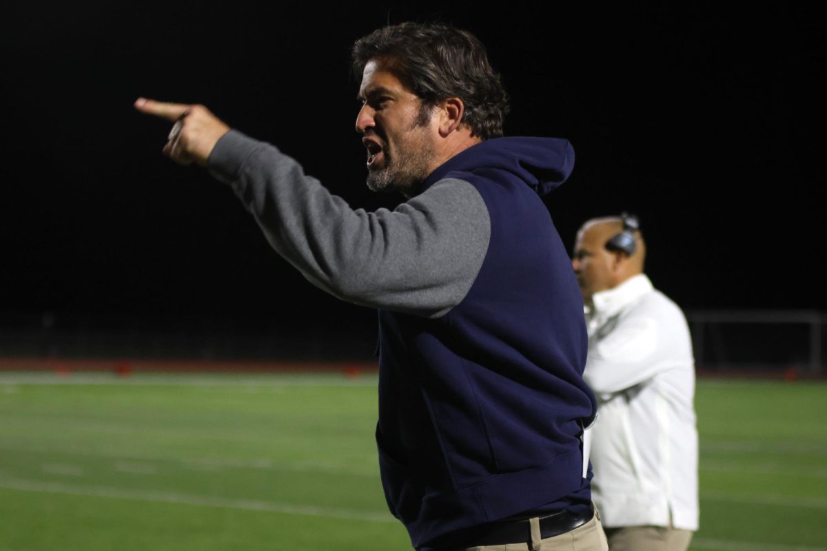 Upset by one of many penalty calls during the second half of the game, coach Michael Strack argues with the referees on the field.