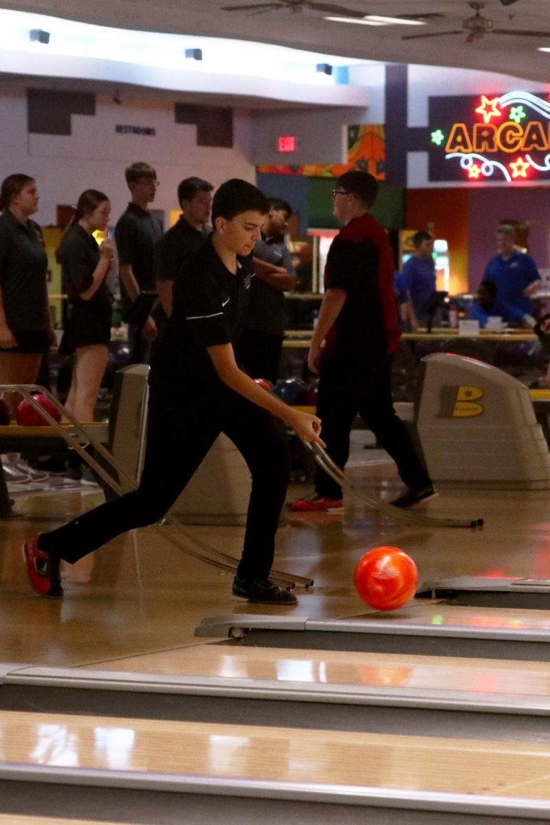  Focusing, _______ tosses the bowling ball down the alley.
