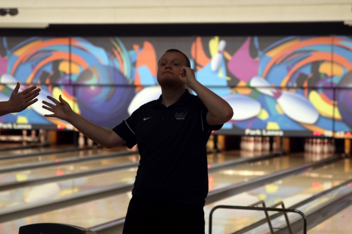 Senior Gus Gosch celebrates with a high five.
