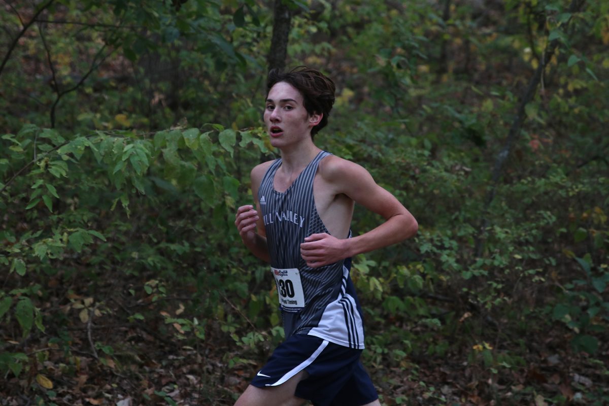 Pushing himself, sophomore Carson Curry races through the trails at Rim Rock Farm. 