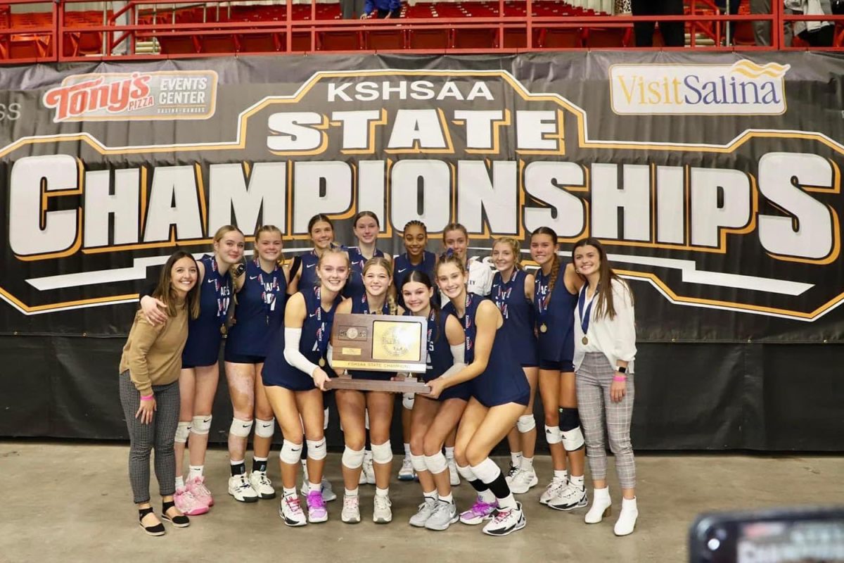 The team celebrated together after receiving the title trophy at Tonys Pizza Event Center Saturday, Oct. 28.