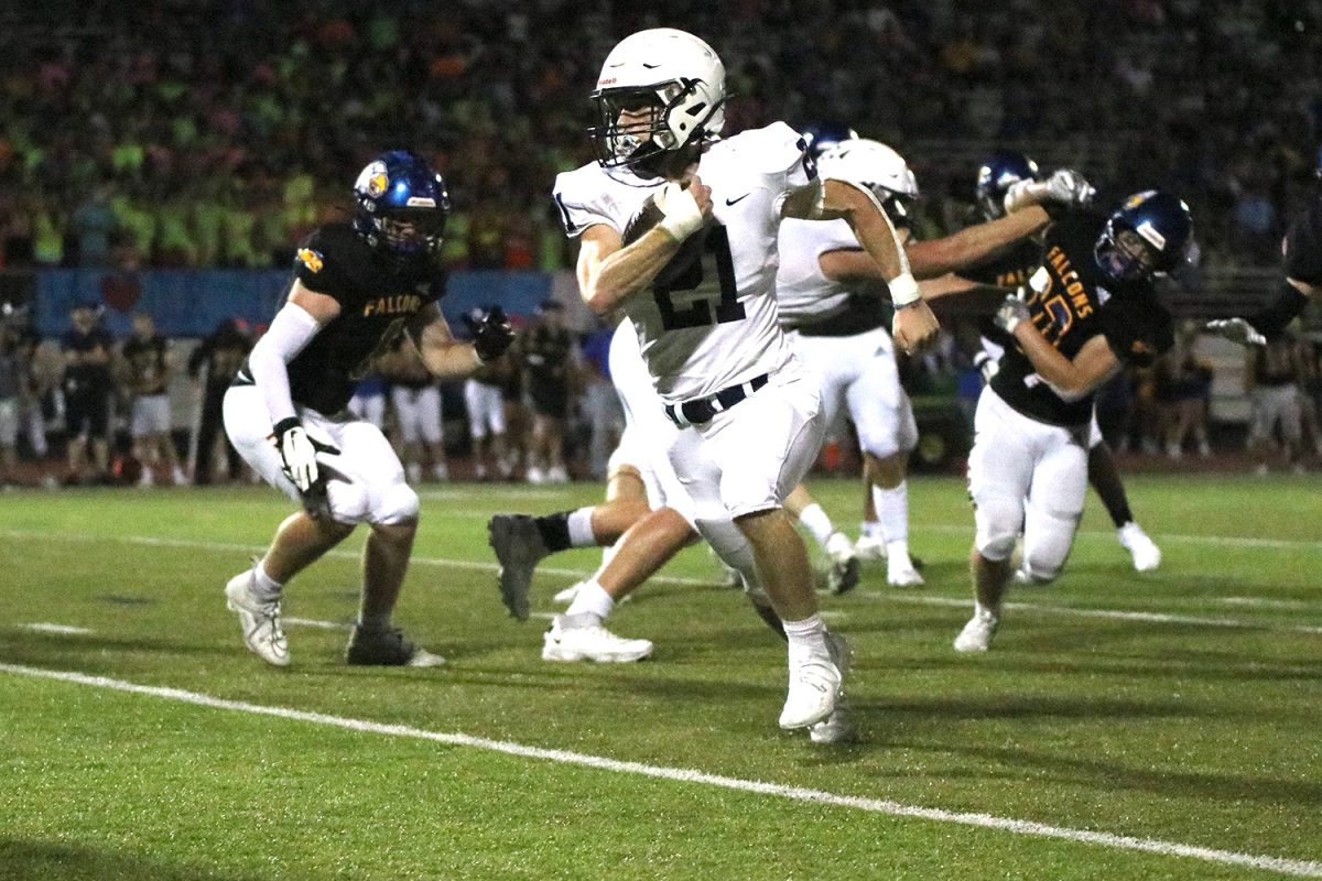 With defenders on his trail, Senior Tristan Baker runs for a touchdown.