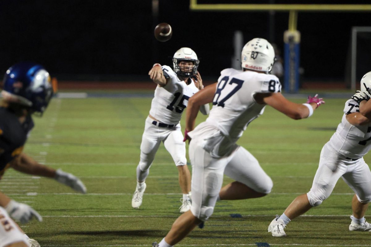 Passing the ball for a touchdown, senior Daniel Blaine connects with junior Brody Brigham to gain the lead. 
