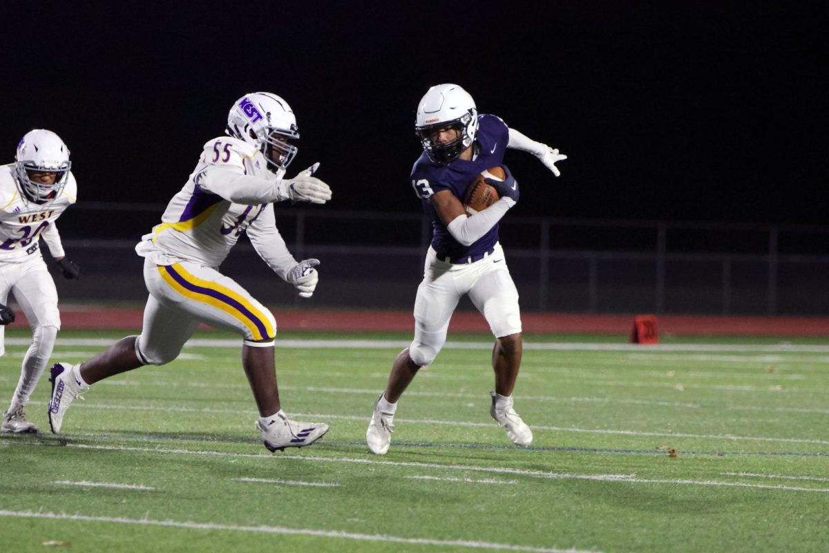 Returning a punt, junior Desmon Williams rushes toward the endzone.