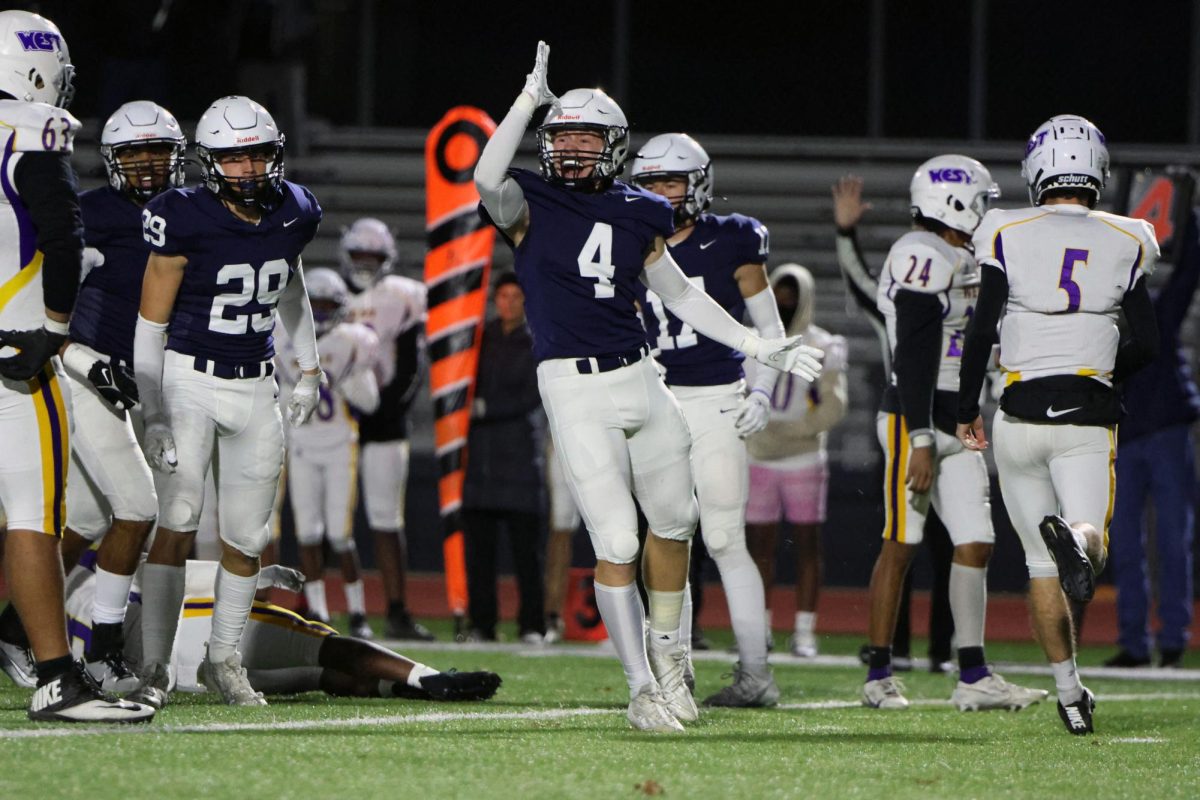 Throwing up the landshark celebration, senior Garrett Cronin gets excited after his sack.