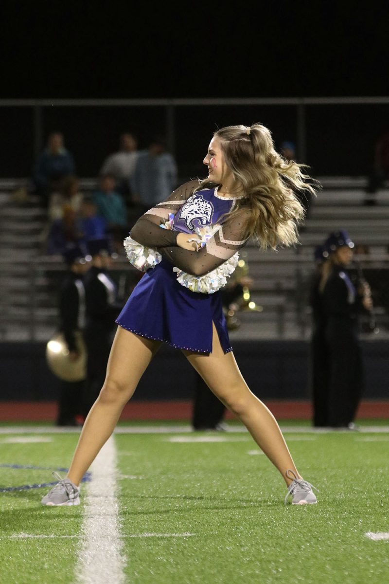 While performing at halftime, sophomore Addison Maier strikes a pose.