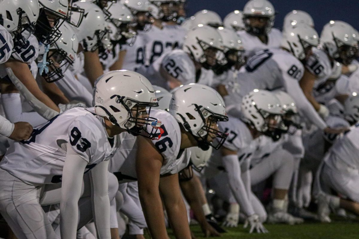 During the coinflip, junior CJ Tilley and his teammates wait for the captions to return.