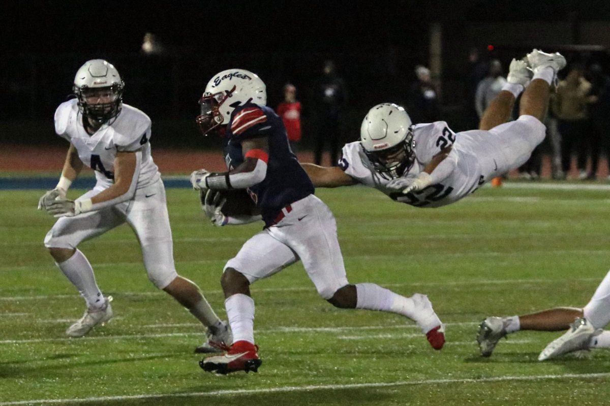 With his hands stretched, senior Evan Seifert dives to make the tackle 