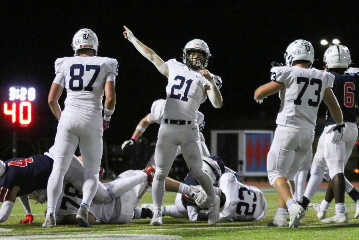 After a fumble, senior Tristan Baker points signaling that we recovered the ball. 