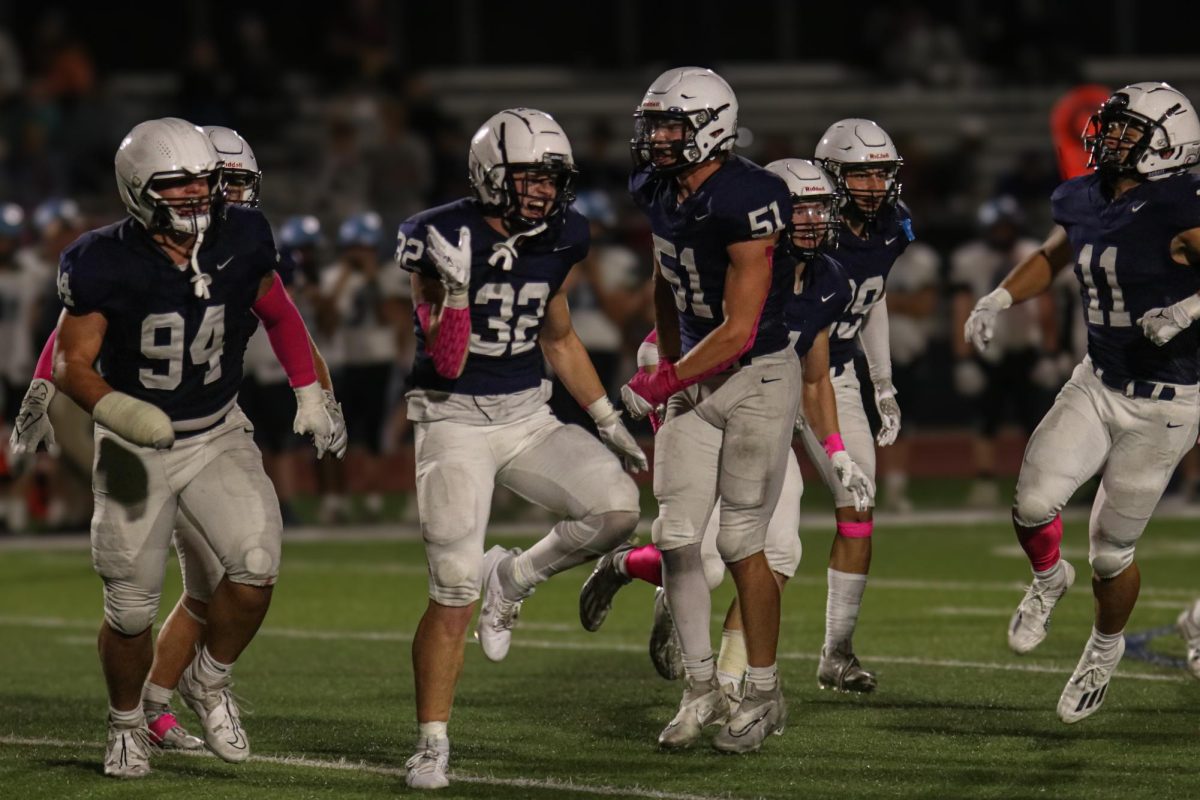 After an interception, junior Garret Clark celebrates with his team.