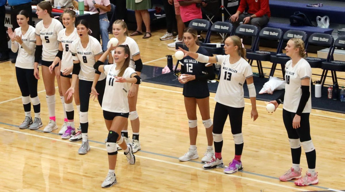 With a big smile, sophomore Ella Florez throws her ball into the crowd.