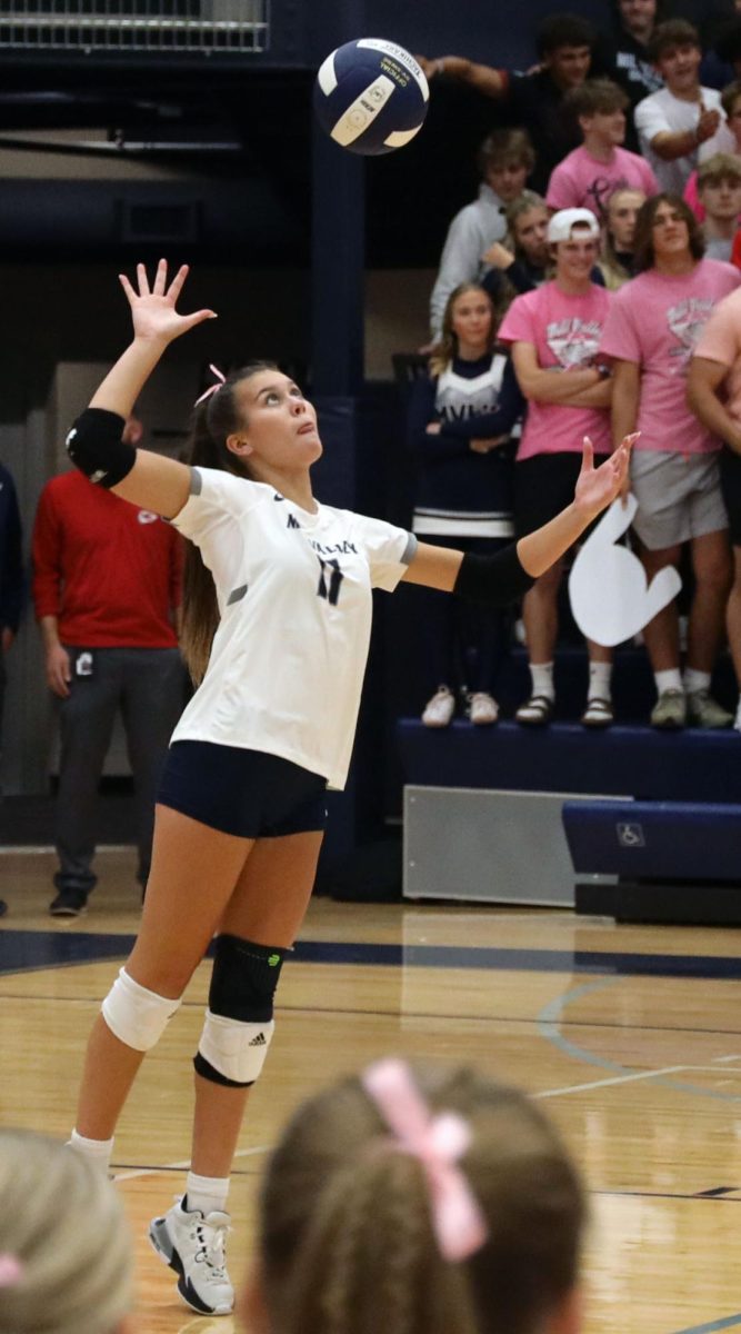 Extremely focused, sophomore Ella Florez serves the ball. 