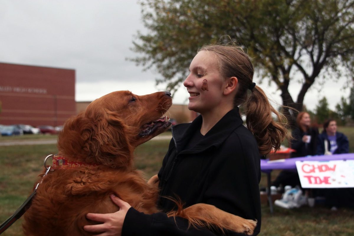 Smiling and hugging her dog, sophomore Abby Heinish enjoys Bark for Life.
