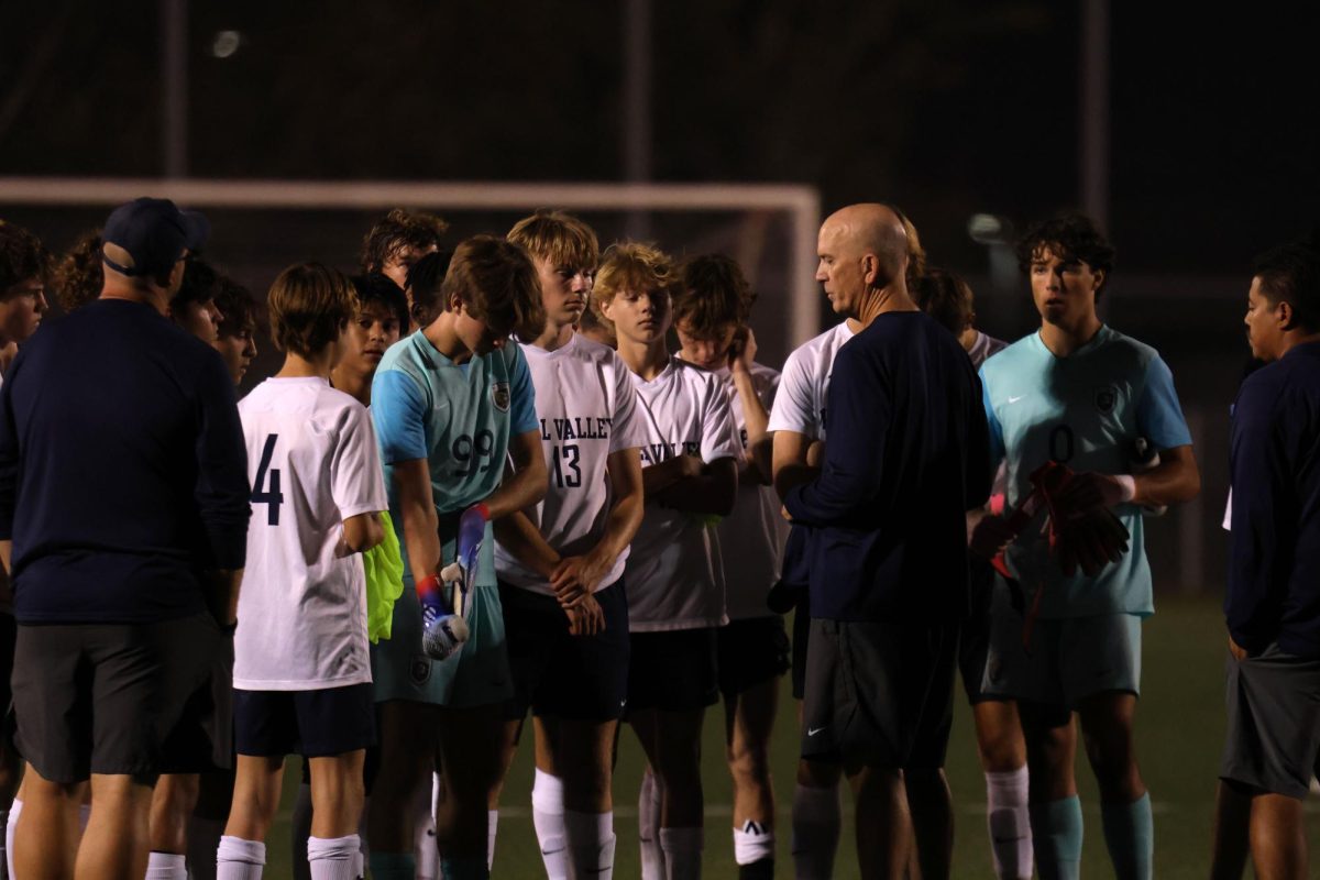 After the game, head coach Jason Pendleton talks to the disappointed team.