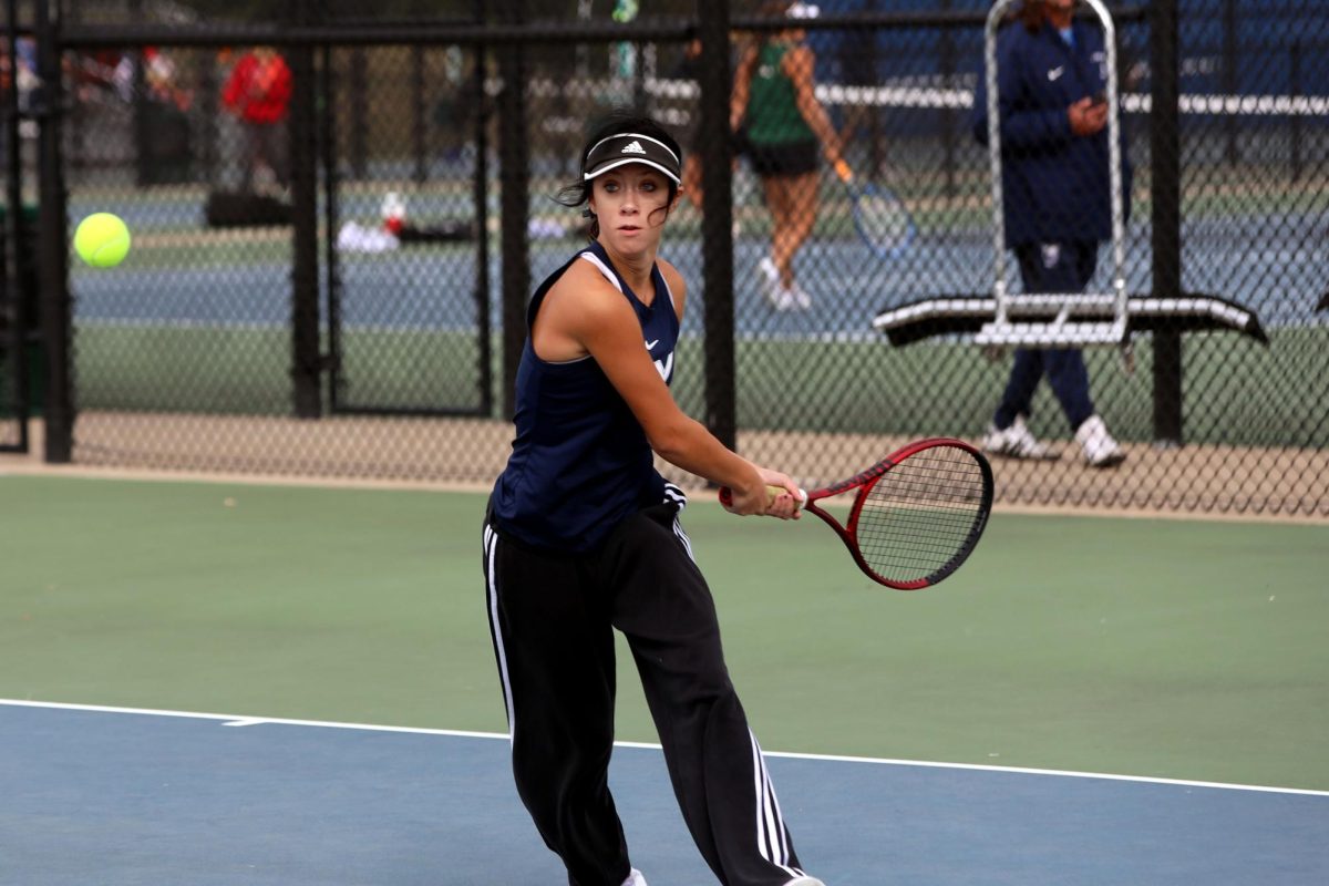 Sophomore Heidi Baillos swings her racket back to hit the ball from her opponent. 
