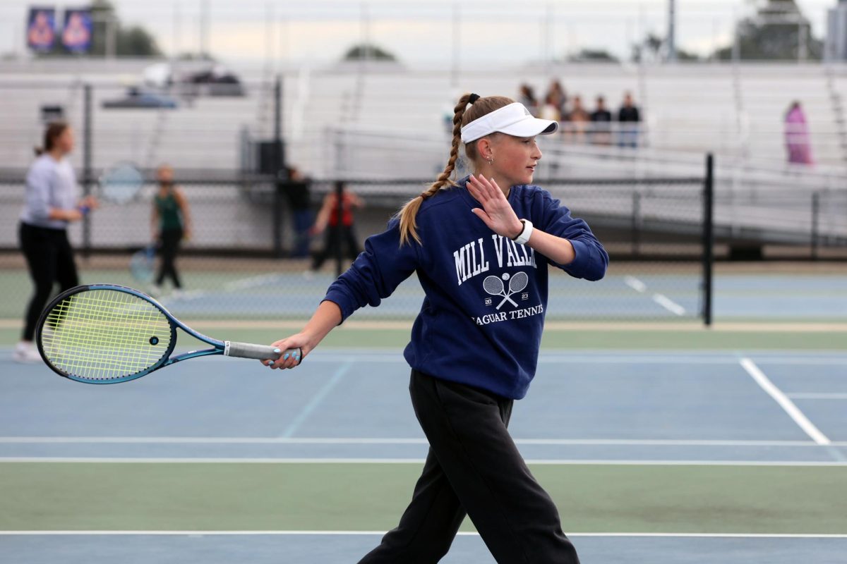 In a ready stance, junior Stella Platt prepares to hit the ball.