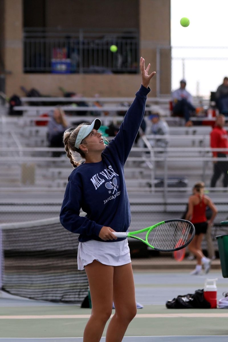 In between points, senior Bella Dumler catches the ball from her opponents. 