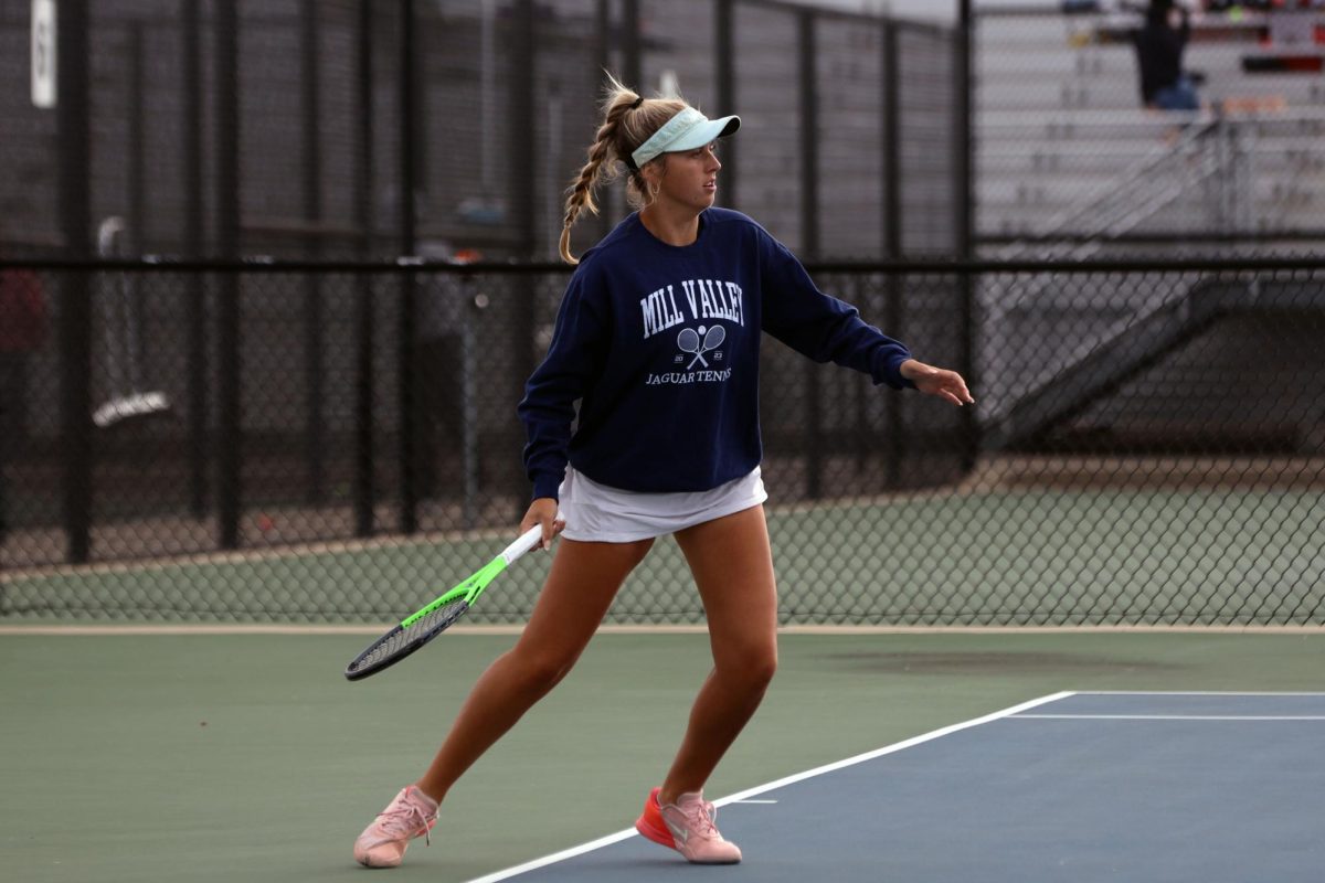 Senior Bella Dumler lunges as she prepares to hit the ball.