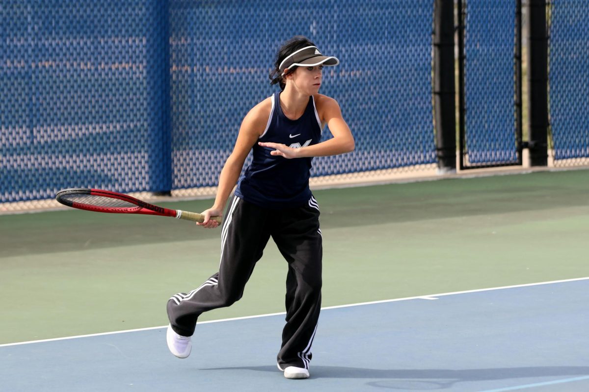 With a focused expression, sophomore Heidi Baillos runs to return the ball. 
