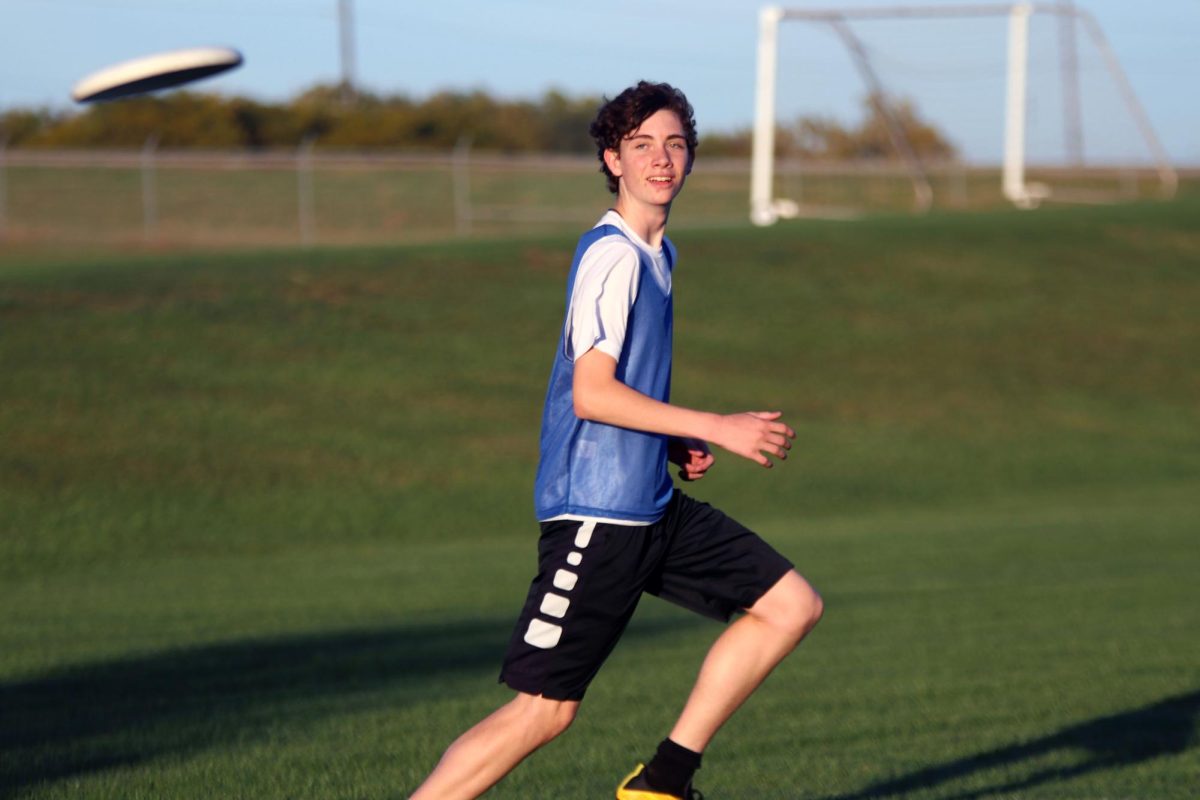 Focused, sophomore Ethan Culver runs to catch the frisbee.
