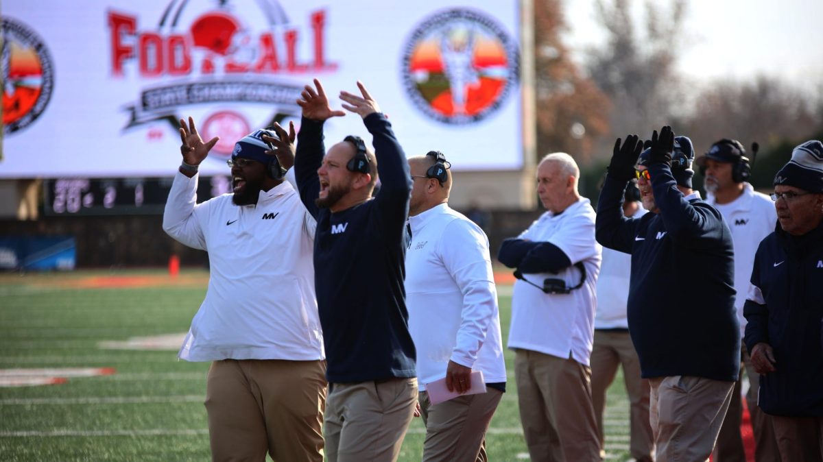 Coaches Derrion Brooks, Jamie Resseguie and Cory Wurtz call out signs to the offense. 