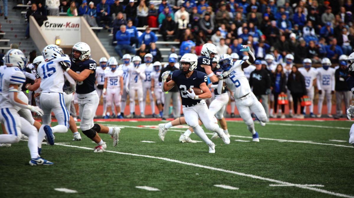 Senior Jaden Scobee runs with the ball to the end zone during the second half of the game. 