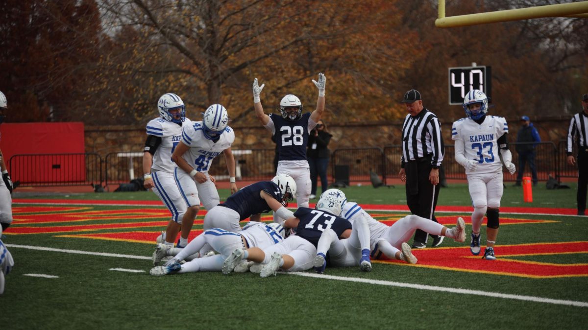 Junior Andrew Watts puts his hands up after the ball across the goal line in the second half of the game. 