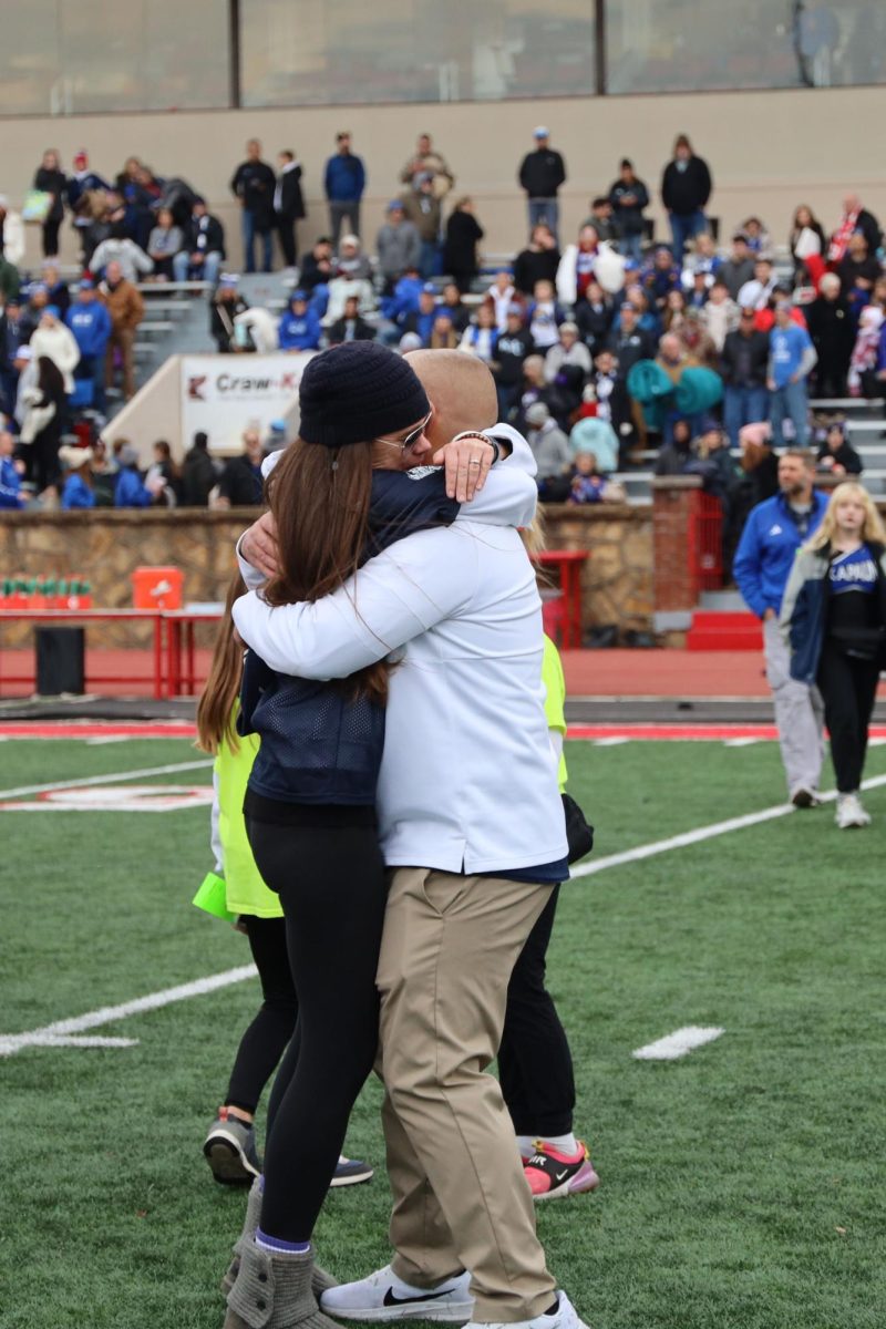 Head coach Joel Applebee hugs his wife after the game.