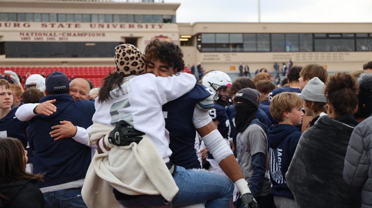 Junior Jayden Woods hugs his mom after the game. 