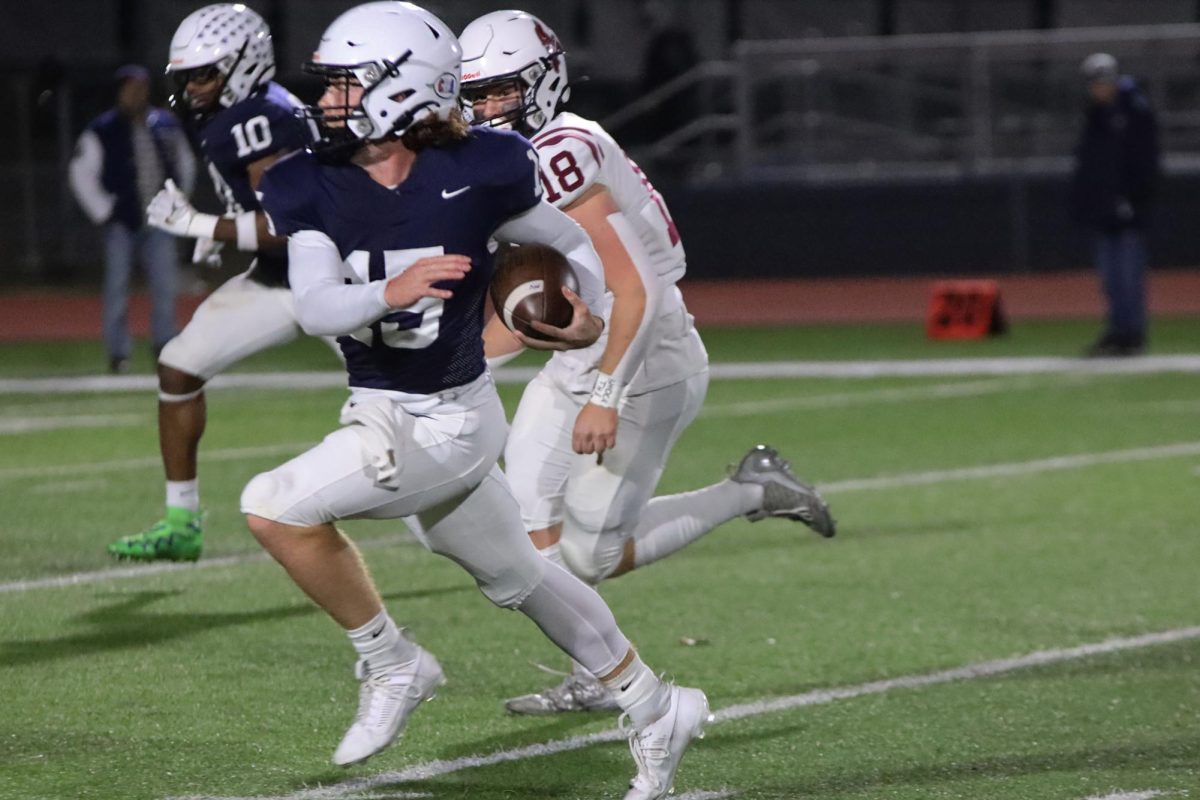 Senior Daniel Blaine runs with the ball down the field.