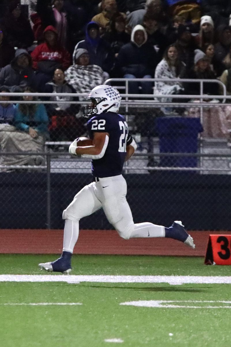 Senior Evan Seifert runs with the football down the field to get a touch down.