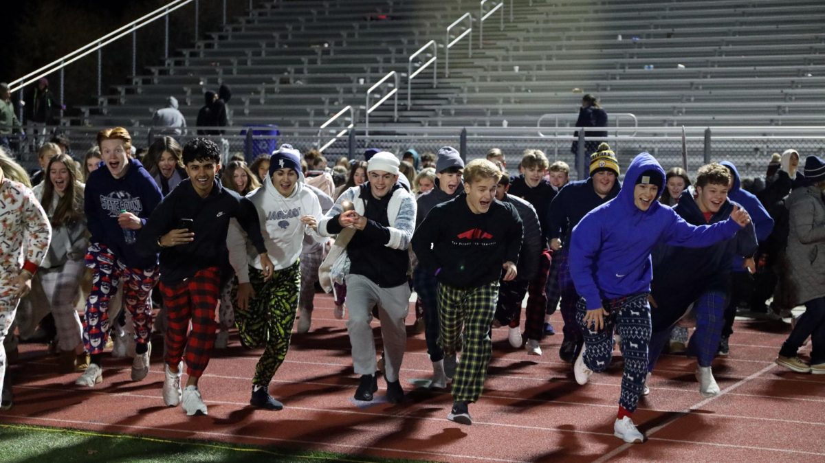 Seniors Arpit Toor, Josh Breninger, Maddox Casella, Drew Snyder and Dylan Judd rush the field after the game .