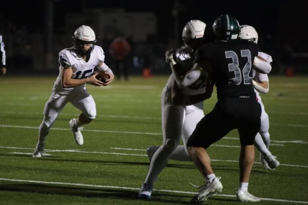 Senior Daniel Blaine runs through a gap to get a touchdown