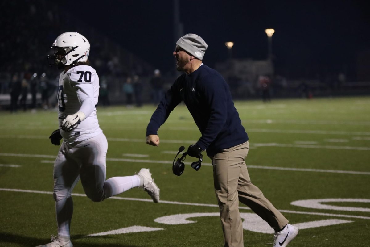 Assistant coach Jamie Resseguie gets excited after a touchdown was scored.