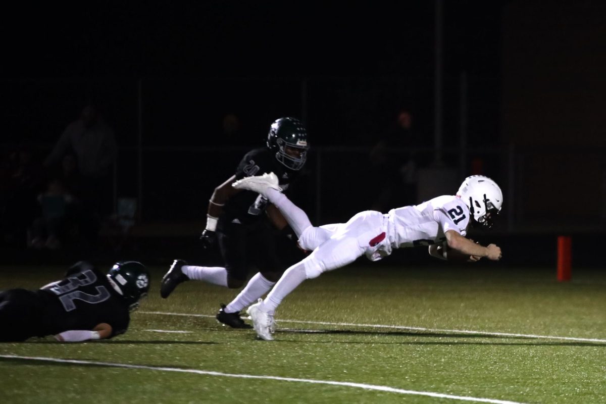 Senior Tristan Baker dives into the end-zone to get a touchdown.