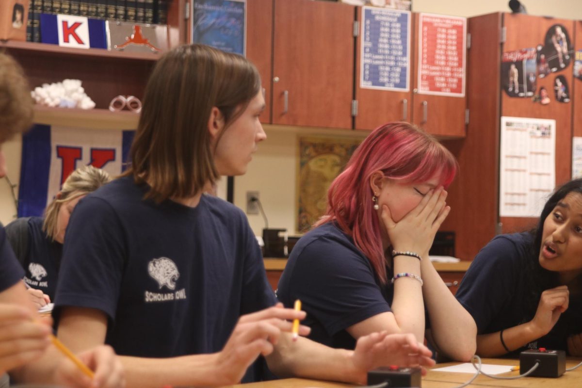 Disappointed after getting a question wrong, senior Emma Clement rests her head in her hands.