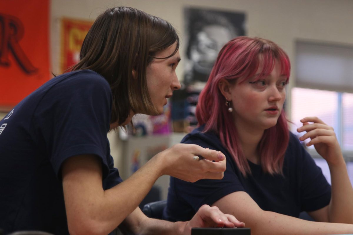 Discussing their answer, seniors Georgia Hansen and Emma Clement intently look ahead.