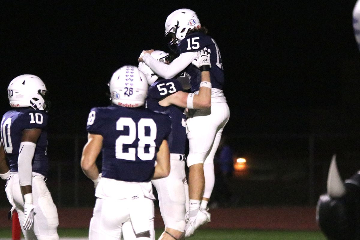 Following a successful touchdown, senior quarterback Daniel Blaine is lifted up by senior offensive lineman Mason Kemp.