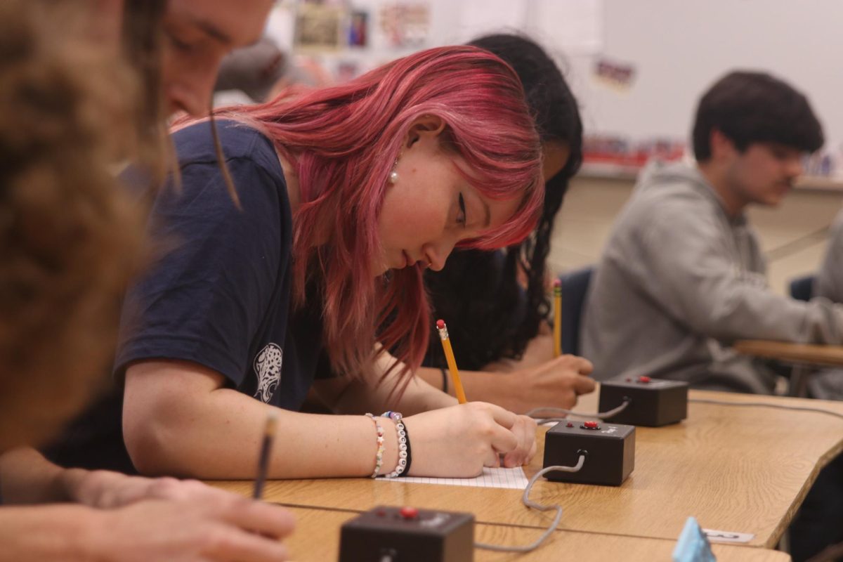 Senior Emma Clement concentrates as she solves math question. 