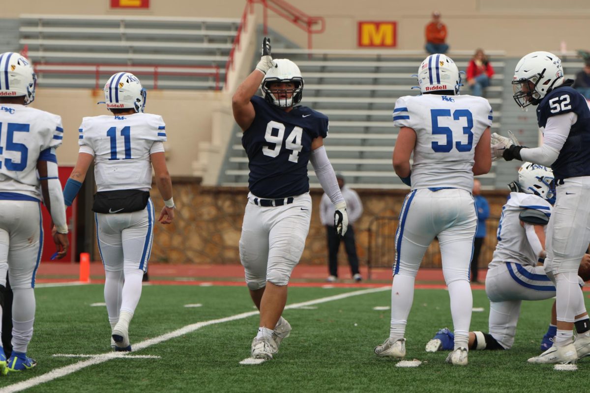 After a tackle for loss, sophomore Hayden Heller puts up the landshark celebration.