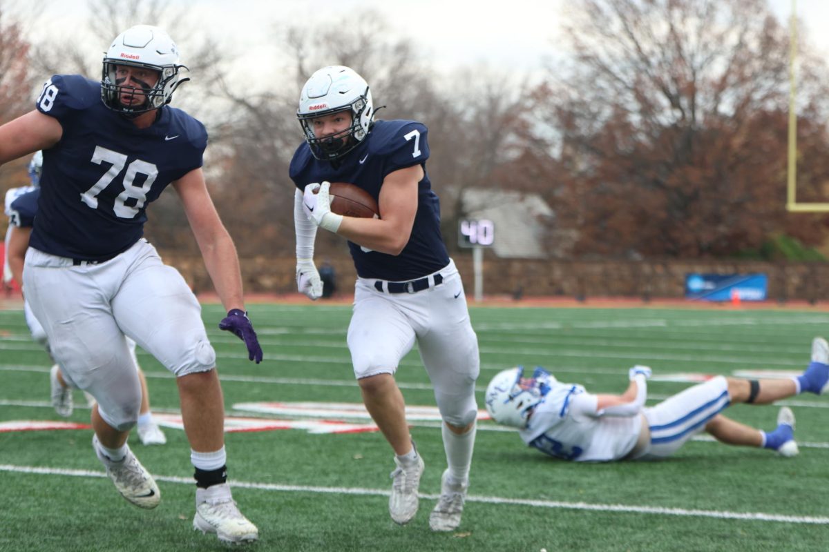 After breaking a tackle, senior Preston Fisher gets behind blockers to make a run toward the end zone. 