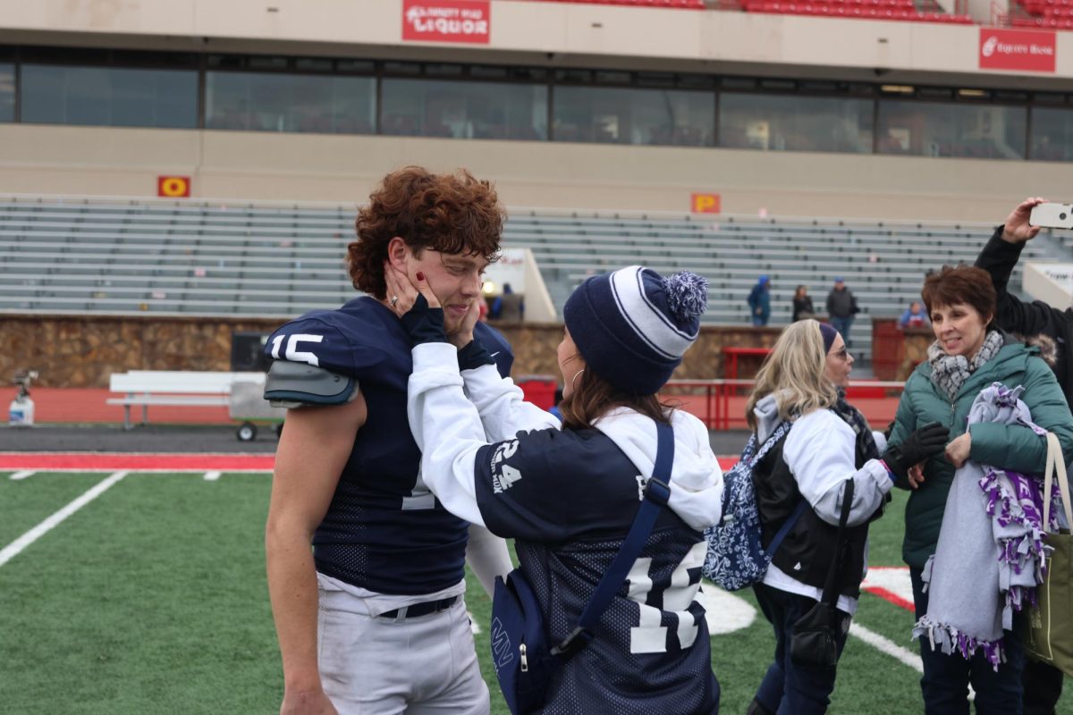 Holding his head in her hands, senior Daniel Blaines mom shares a memorable moment with her son.