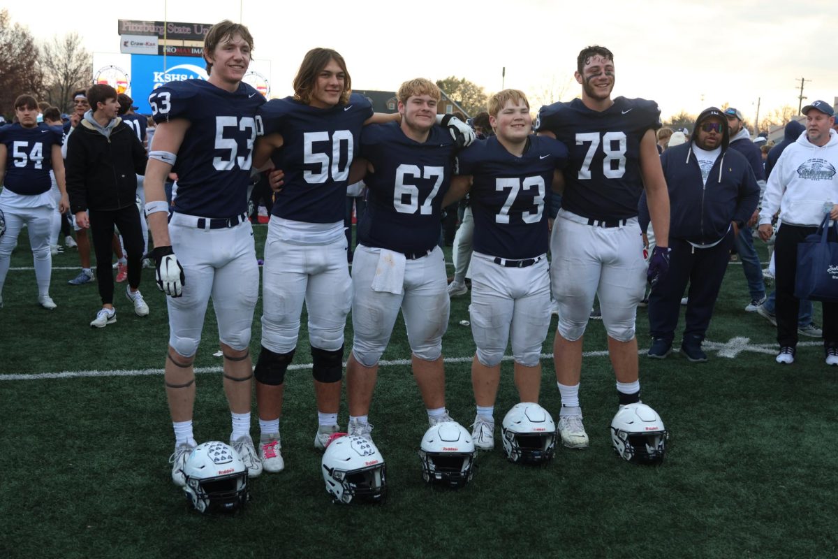 For the final time, the offensive line poses for their post game picture. 