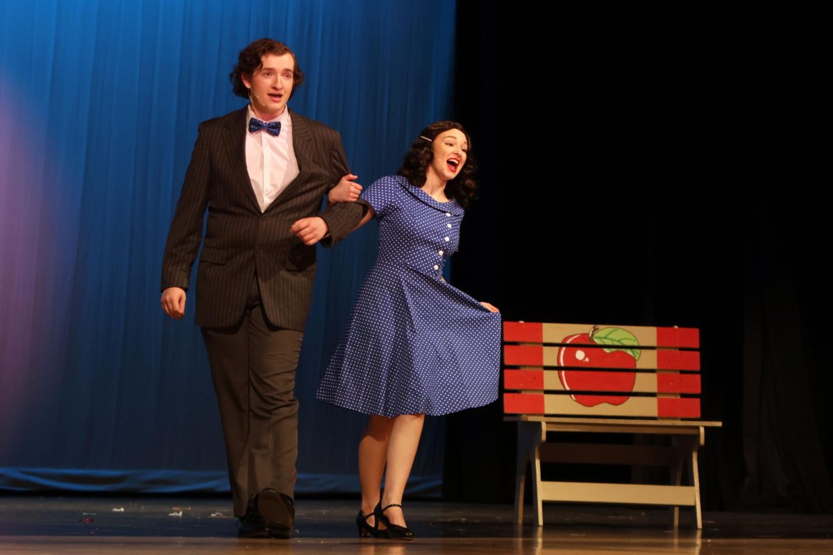 Linked at the arm, Albert Peterson, played by junior Blake Gray, dances with Rose Alvarez, played by Grace Cormany, to “Rosie.”