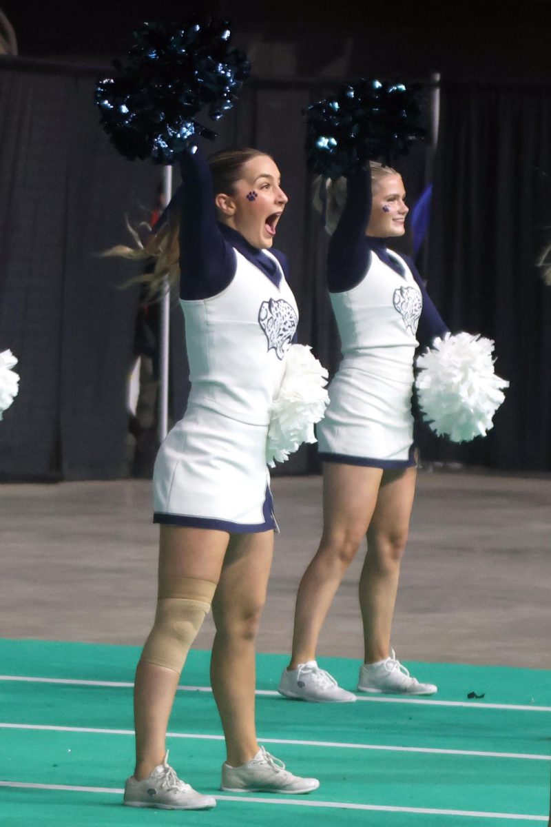 Performing the fight song routine, senior Maddie Epperson and freshman Olivia Pearce strike a pose. 
