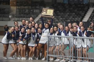 Holding up the state trophy, sophomore Ava Lucht poses with her team. 
