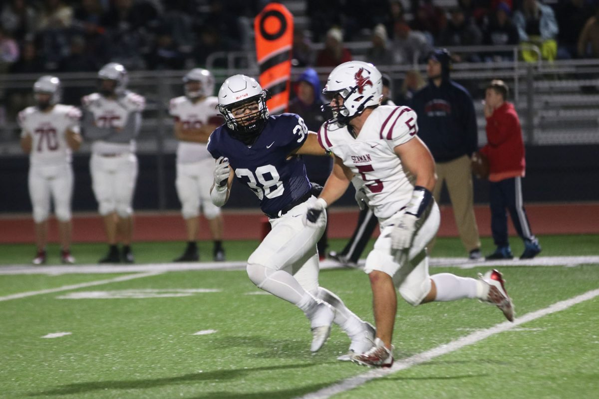 Keeping an eye on his opponent, junior Zach Zaldivar runs downfield.